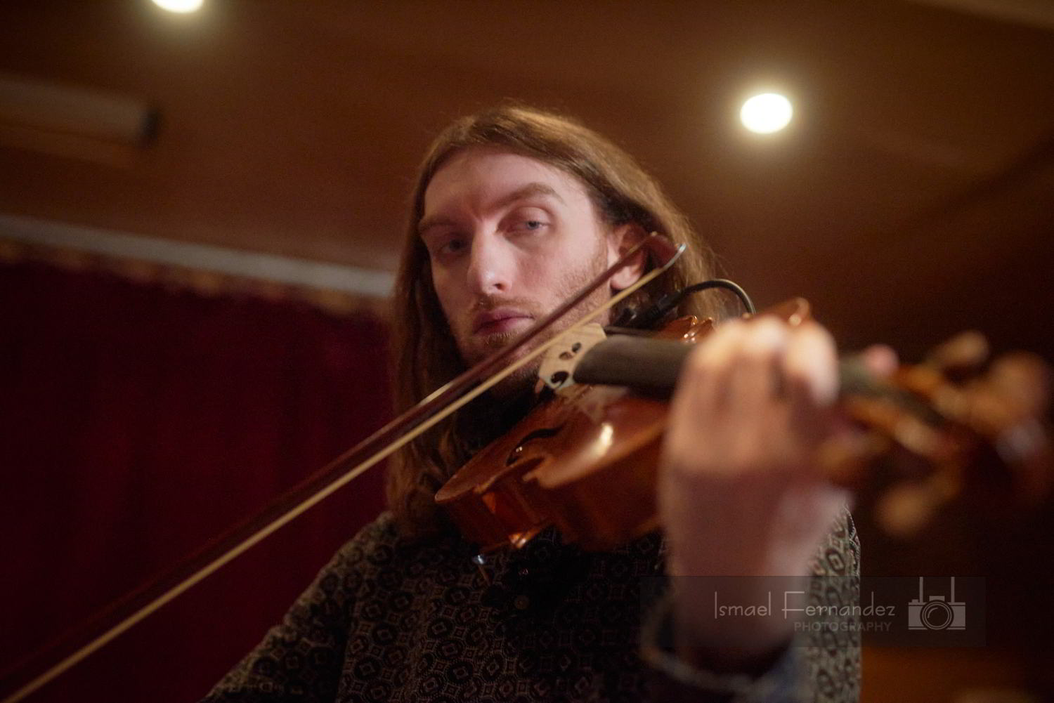 Evan stares down his viola as he plays. 